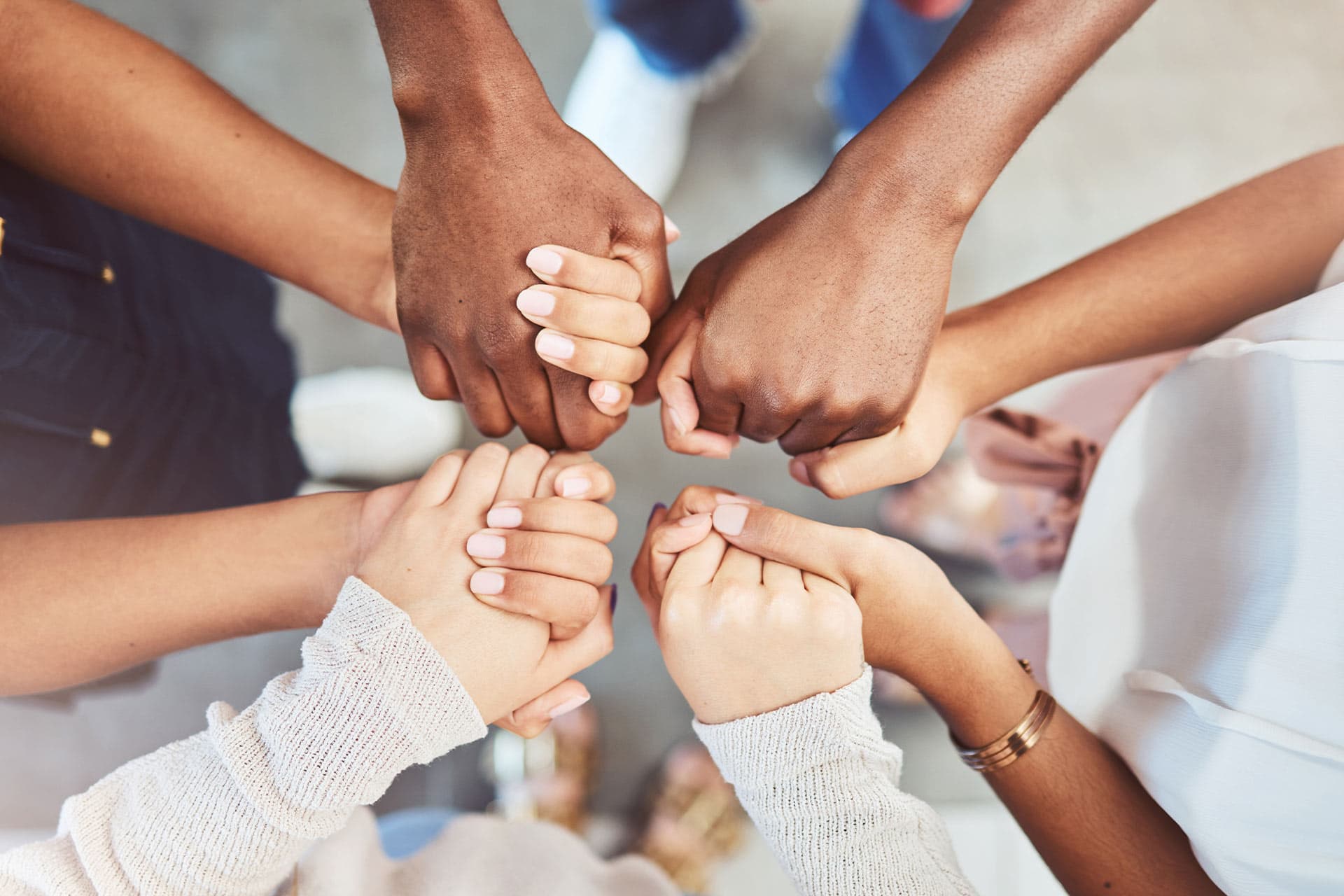 Supportive hands during a group healing session